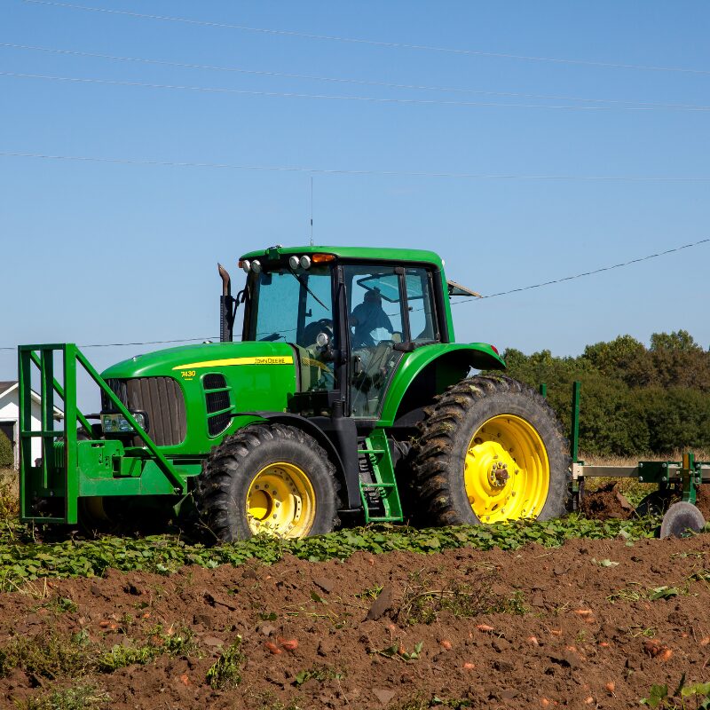 Close-up of a high-speed disc in a field, attached to agricultural machinery.
