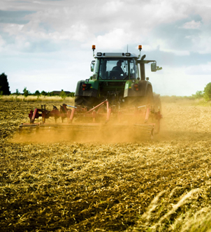 Close-up of a lime spreader machine in action on a farm.